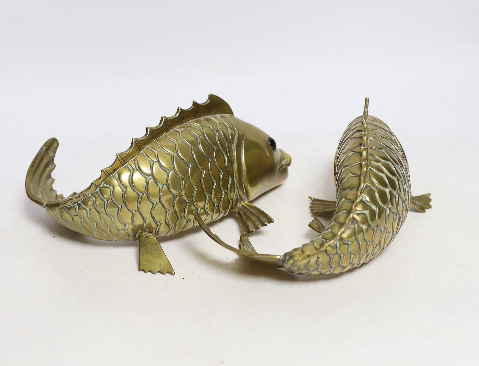 A pair of Chinese polished brass models of carp, 20cm